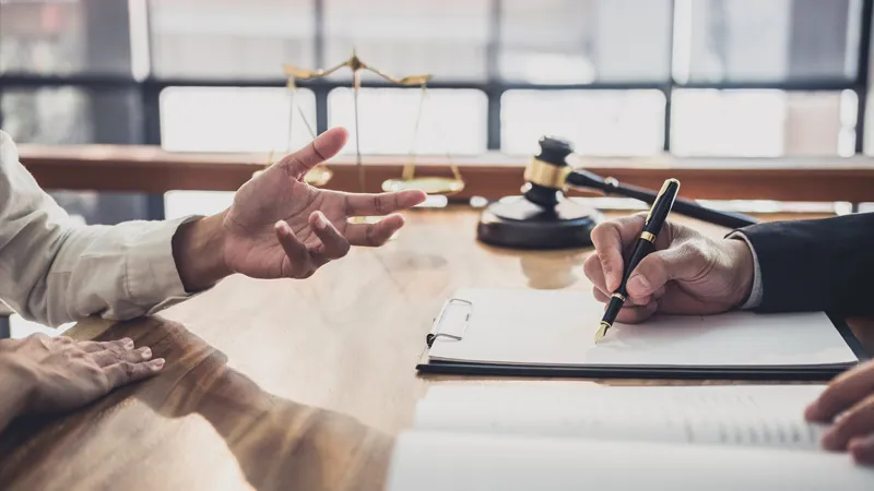 Visual representation of legal proceedings with a defendant gesturing in questioning stance opposite a prosecuting attorney, reflecting themes of pretrial procedures and reform discussed in the article.